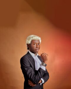 Portrait of a young lawyer wearing a traditional white wig, exuding confidence. Warm tones.