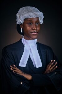 Young female lawyer in traditional attire poses confidently, symbolizing justice and professionalism.
