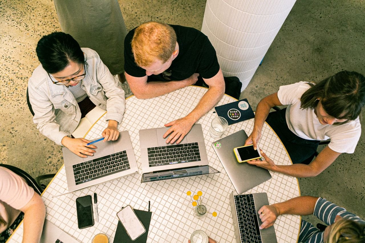 Home Top view of diverse team collaboratively working in a modern office setting.
